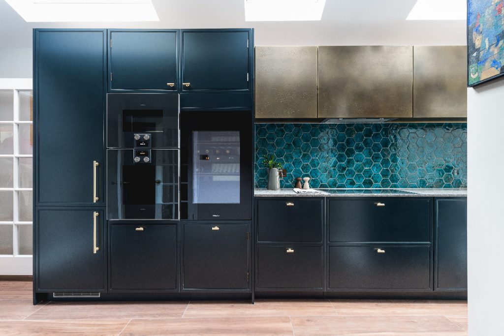 typical navy frame look cupboards next to a splashback with hexagonal turquoise tiles