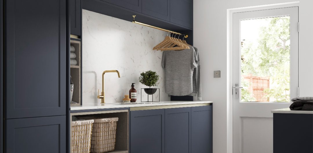 a laundry room featuring navy cabinetry and a wink with brass tap