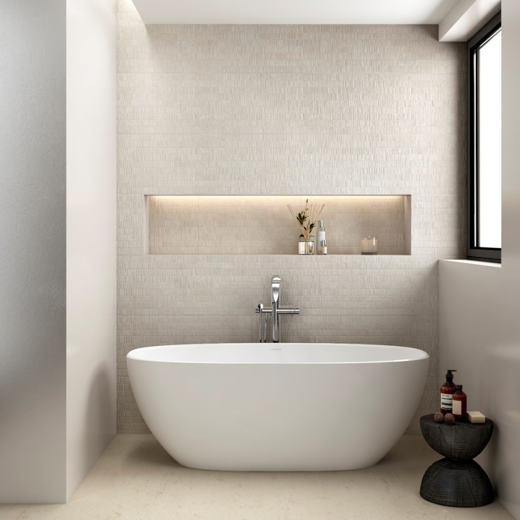 a freestanding white compact bath in a beige bathroom with toiletries and accessories 