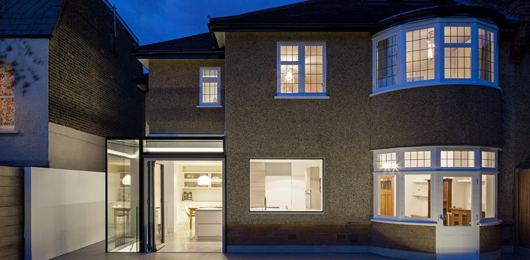 the front of a semi-detached house at night with a kitchen extension