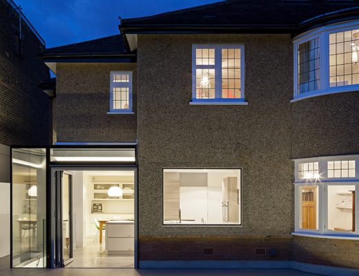 the front of a semi-detached house at night with a kitchen extension