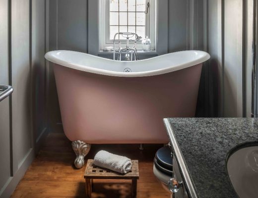 a bronze compact bath in a traditional Victorian bathroom with toiletries and accessories