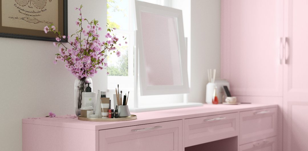 a pastel pink dressing table with a white mirror on top