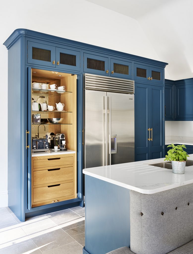 navy Shaker cabinetry with a wooden pantry cupboard and silver fridge