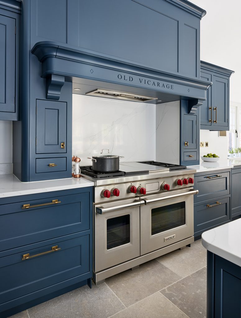 navy cabinetry around a large stainless steel range cooker