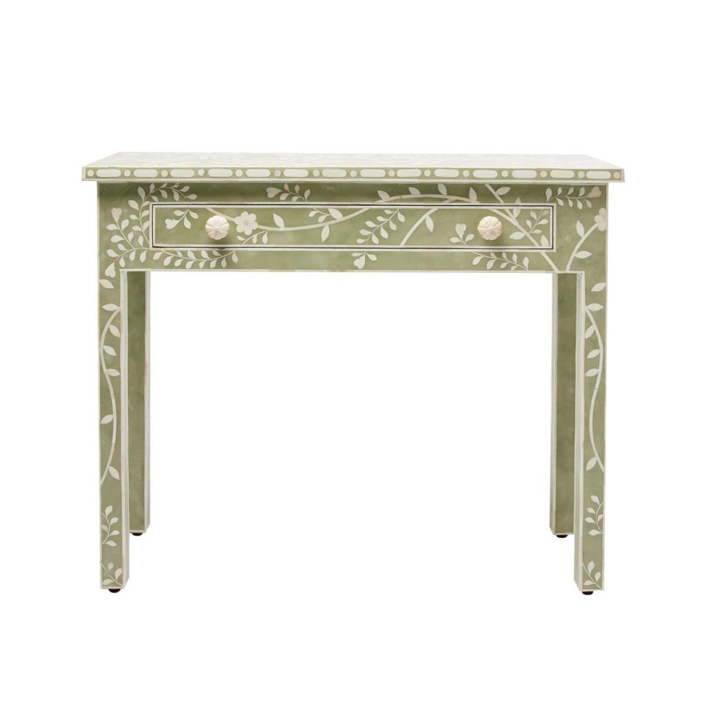 a sage green floral dressing room table