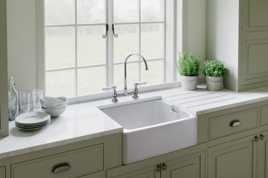 an olive green Shaker kitchen with chrome handles