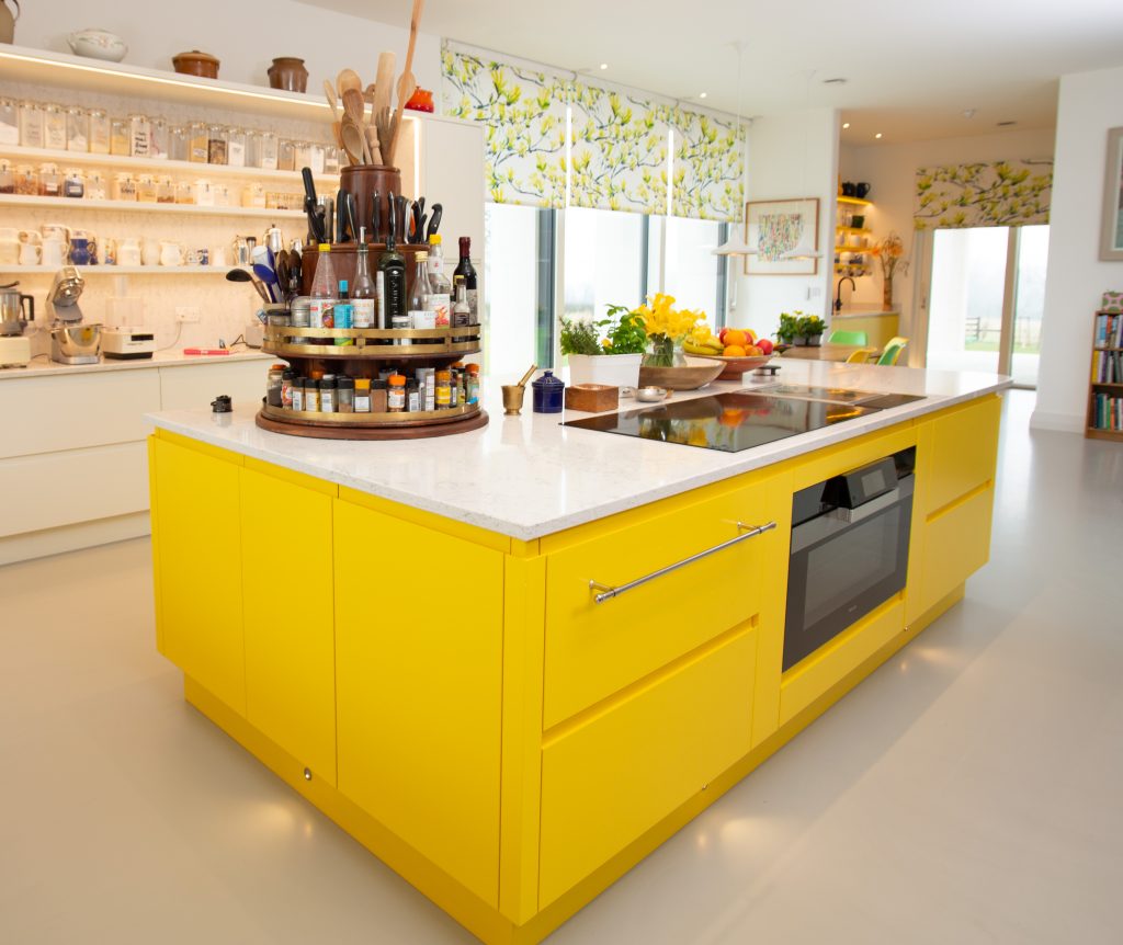 a yellow handleless pro-style kitchen with a central white and yellow kitchen island