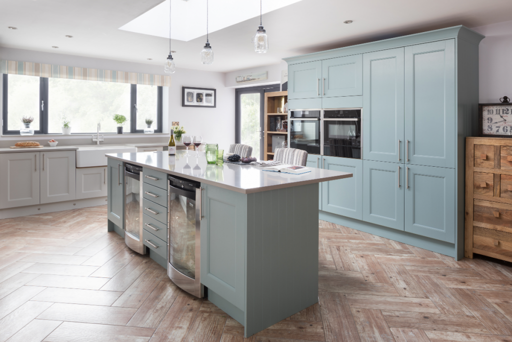 Shaker cabinetry painted in a pastel shade against herringbone flooring