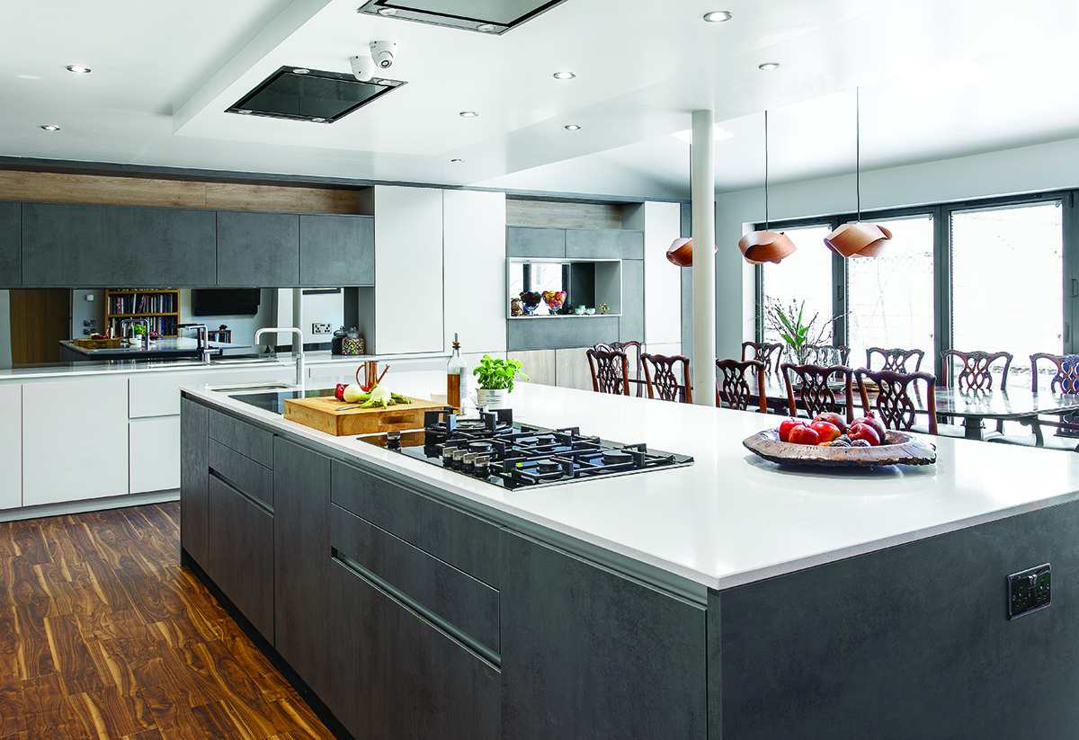 a white and grey kitchen island in a large space