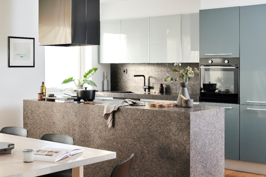 pale blue kitchen units with a dark stone island