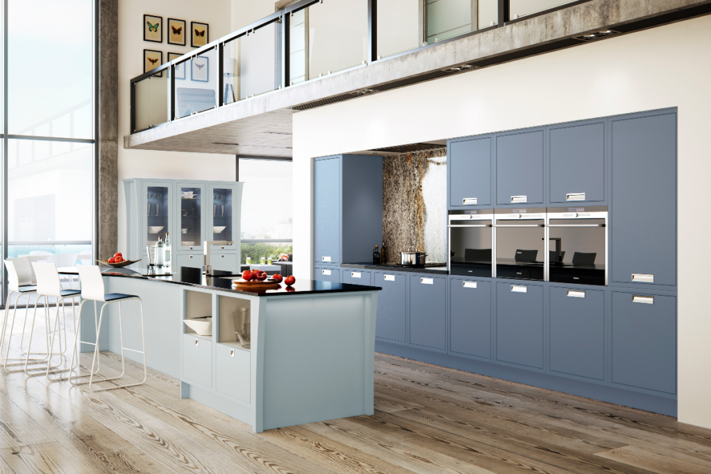 dark blue Shaker cabinetry with silver handles and a muted blue kitchen island with a black worktop