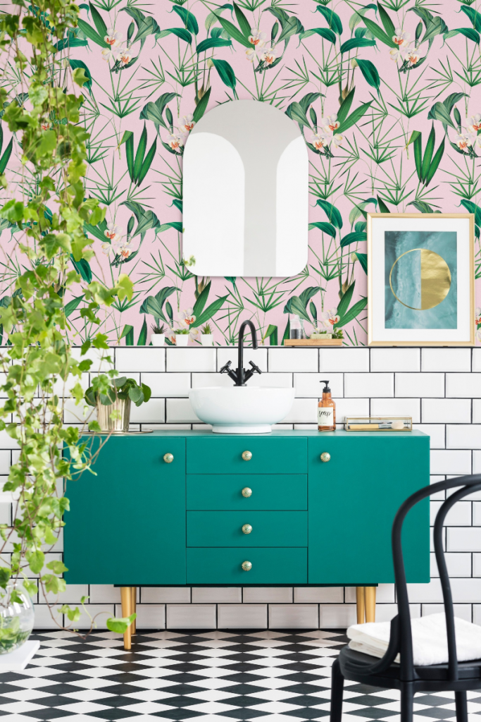 pink and green floral bathroom wallpaper above a jade green vanity unit