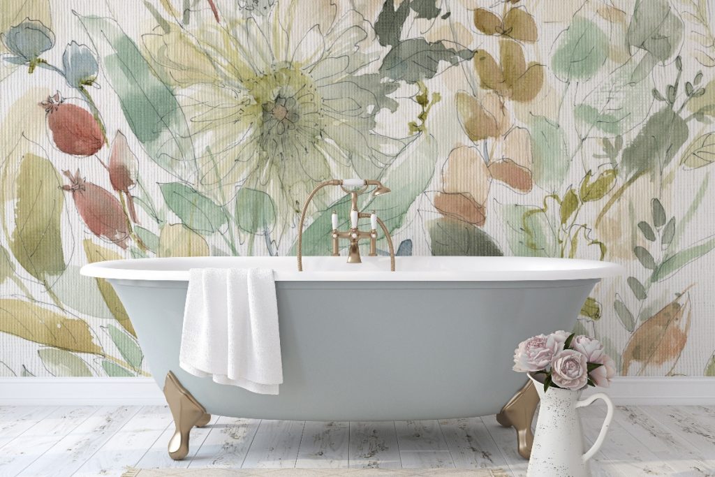 neutral floral bathroom wallpaper above a grey freestanding bath with brass fittings