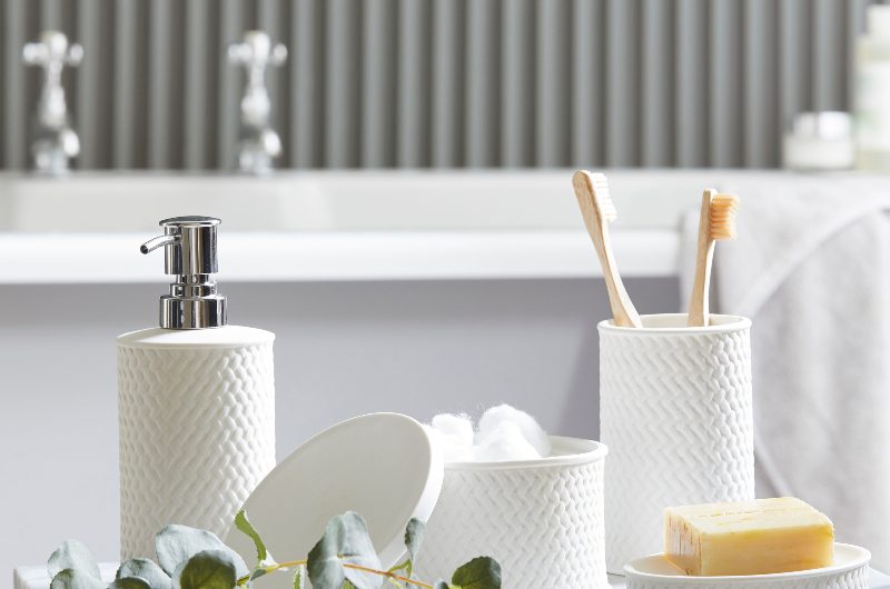 a guest bathroom with a marble stool and a range of white ribbed bathroom accessories 