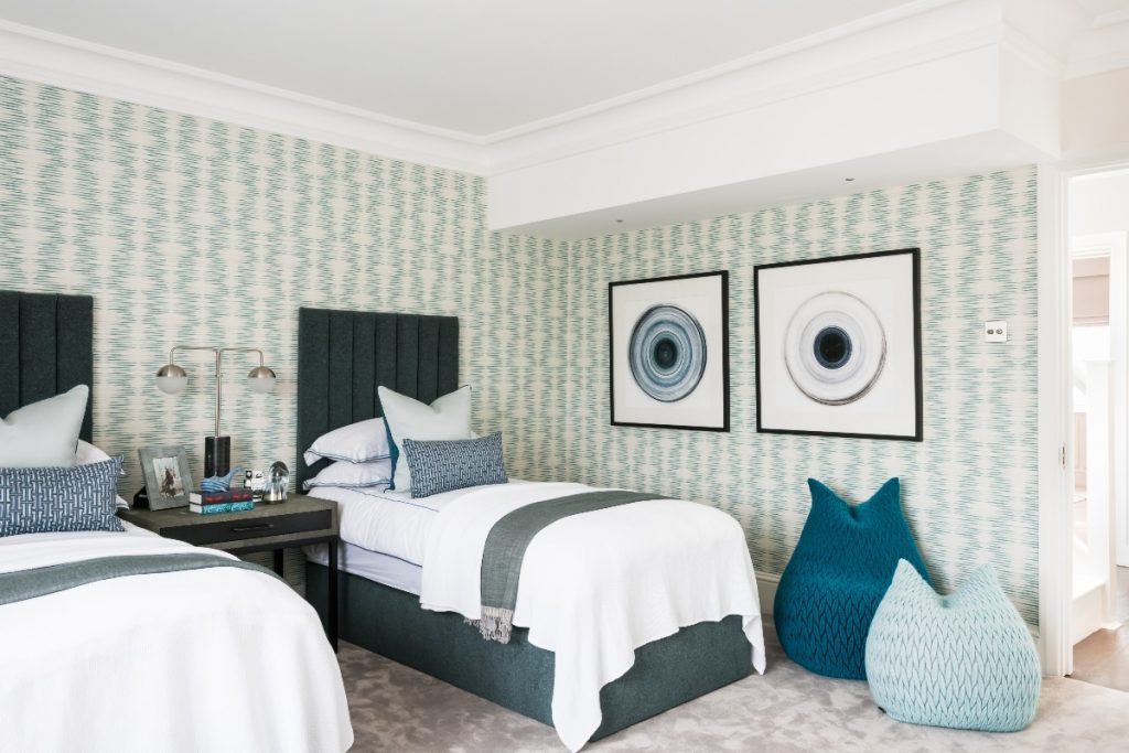 patterned wallpaper next to twin beds