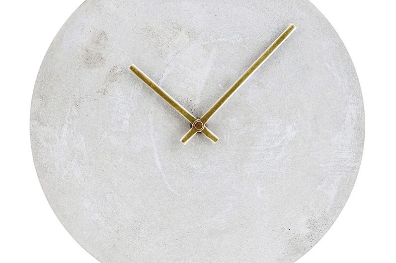 a pale grey concrete clock with brass hands rated one of the best brass products
